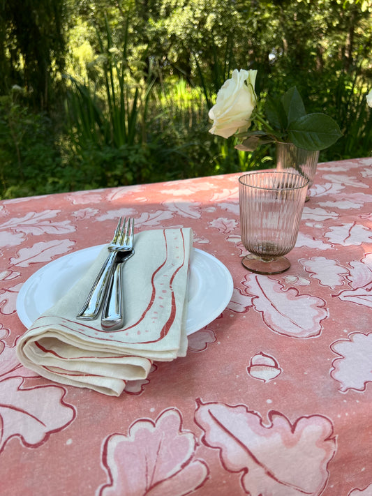 Beautiful Grace Tablecloth in different shades of pink, showcasing oak leaves and acorns across the cloth. 100% Linen.