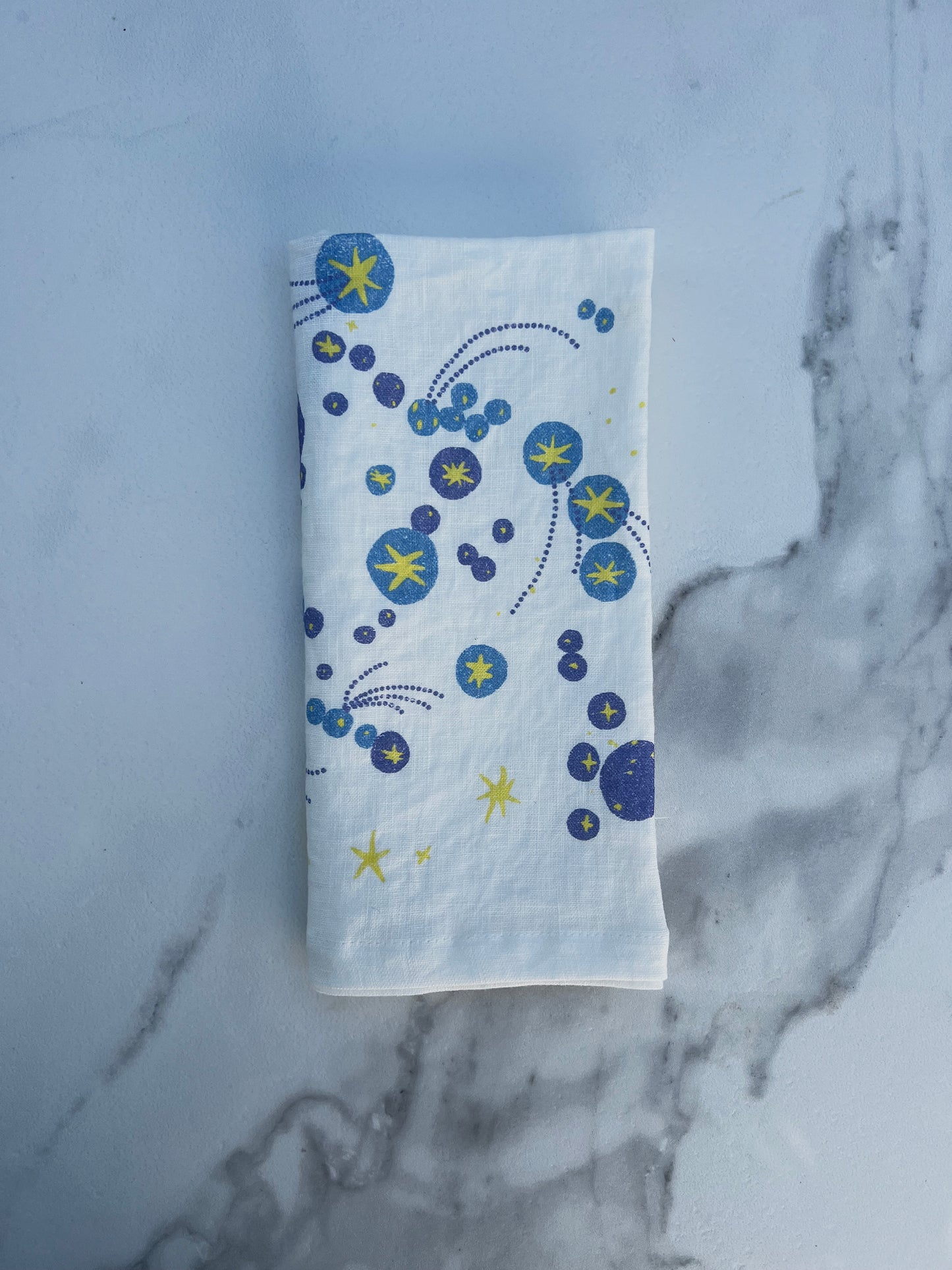 A starburst galaxy and shooting stars waiting to be wished upon. Printed on pure linen, these napkins add a layer of bursting brilliance and joy to any table. A perfect gift to yourself or your host/hostess.