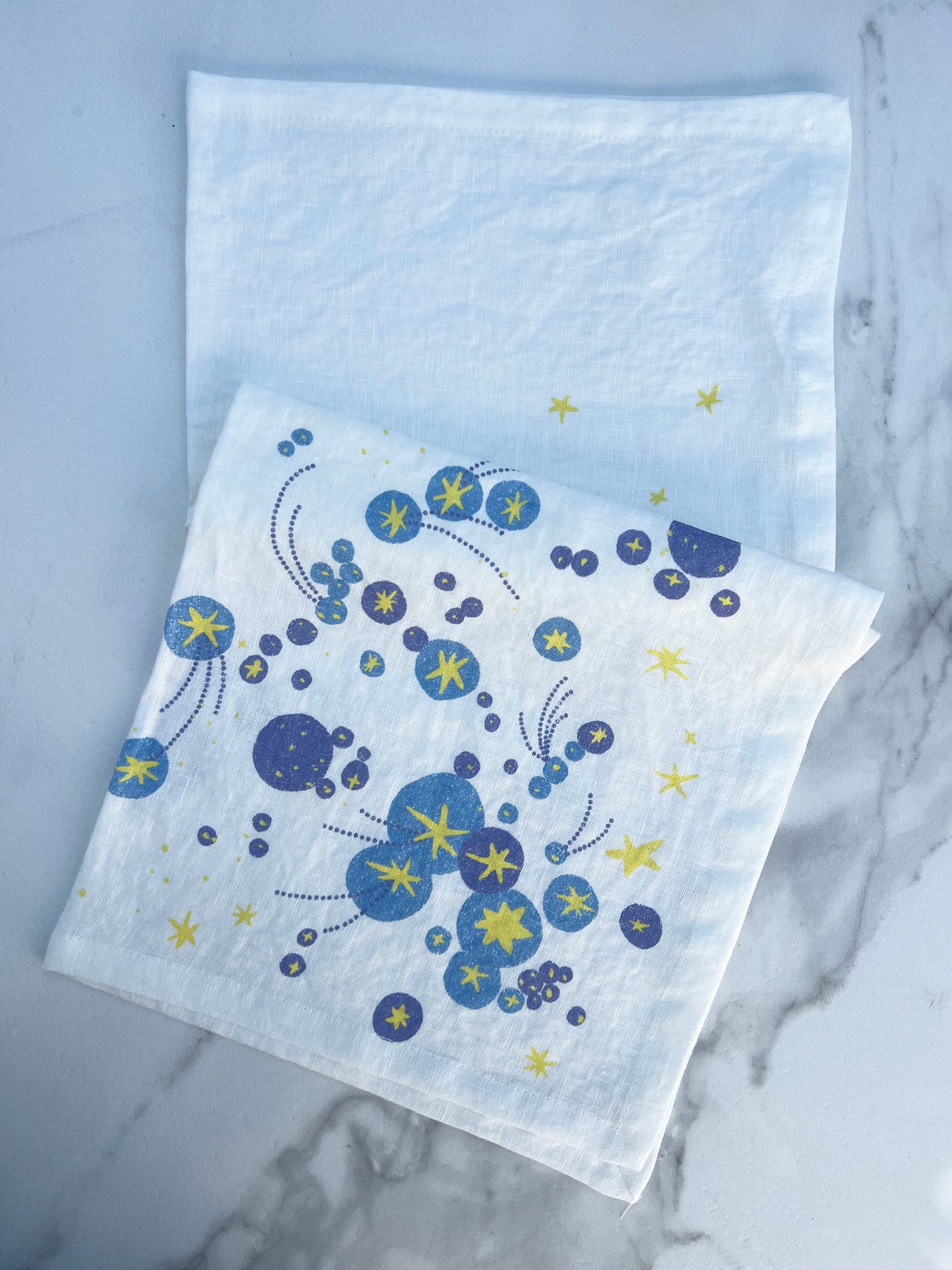 A starburst galaxy and shooting stars waiting to be wished upon. Printed on pure linen, these napkins add a layer of bursting brilliance and joy to any table. A perfect gift to yourself or your host/hostess.