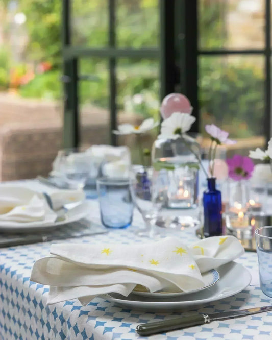 Table setting with blue tablecloth and flowers