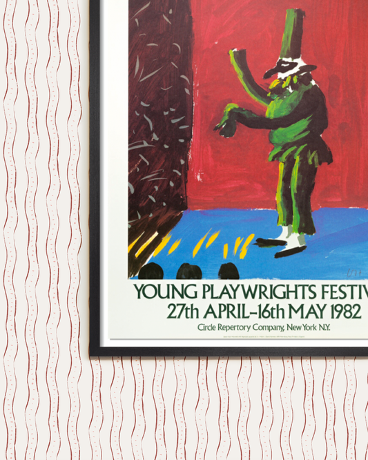 Framed David Hockney poster over wall with striped wallpaper