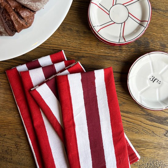 Red striped napkins and chocolate cake on dining table