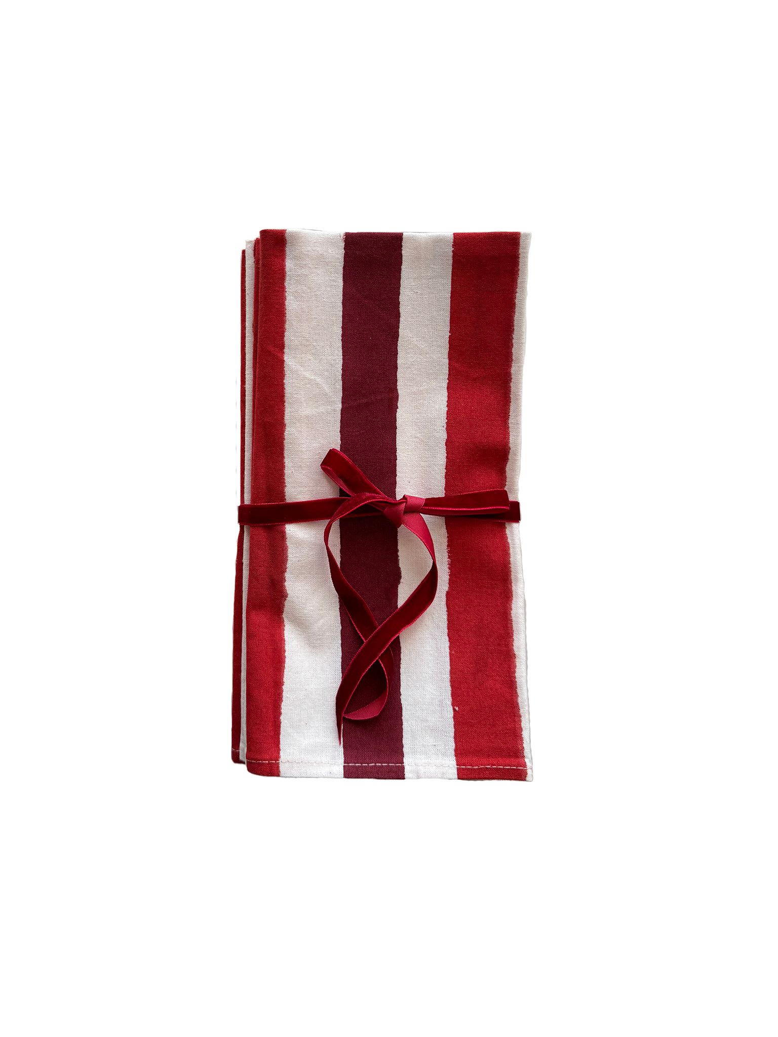 Red striped block printed cotton napkins folded and tied with a red velvet ribbon