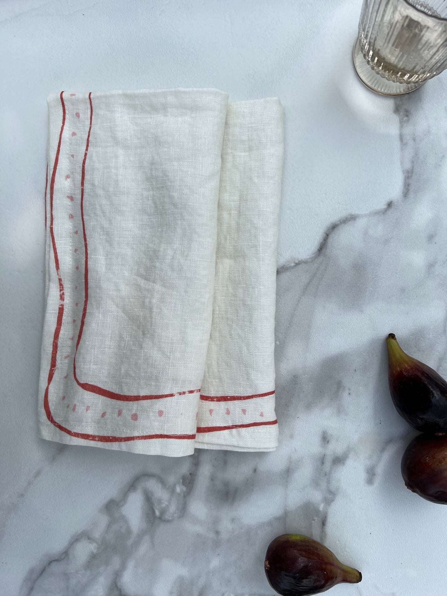 A set of four beautiful linen napkins, graceful and wavy lines napkins wrap around each napkin adding a delicate and timeless look. They are the perfect addition to an elegant and graceful tablescape. Shop beautiful table linen from Lizzet Frausto