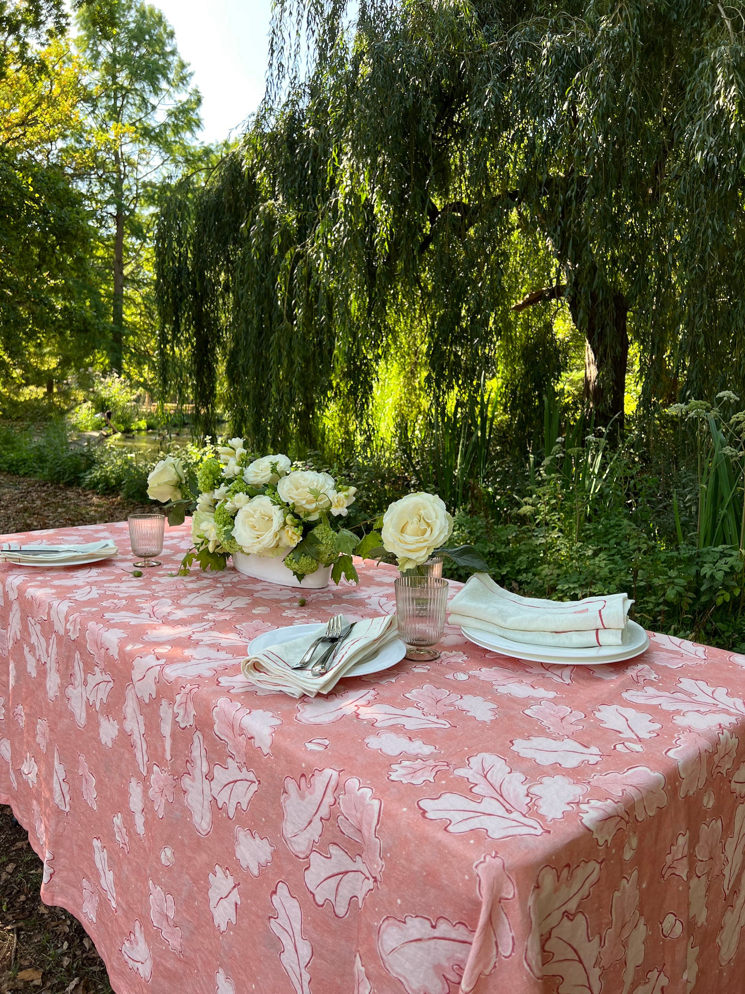 Beautiful Grace Tablecloth in different shades of pink, showcasing oak leaves and acorns across the cloth. 100% Linen.